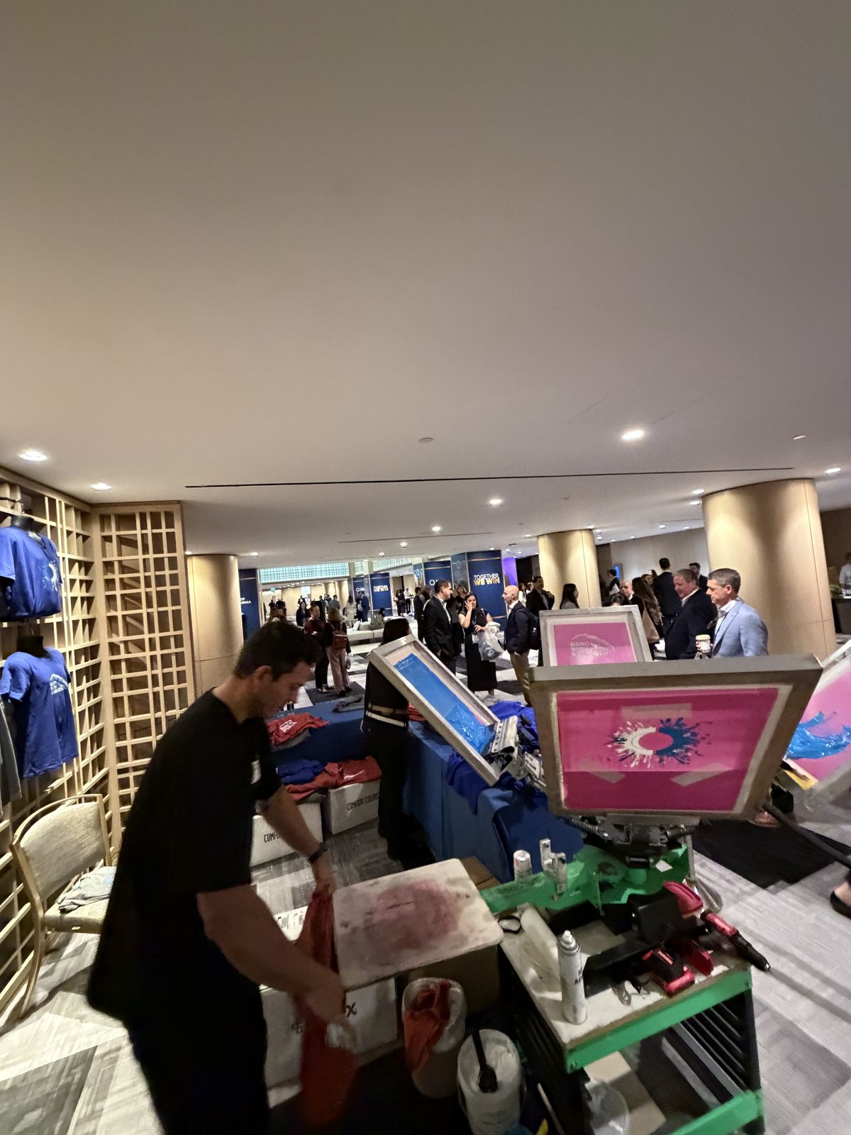 Guests watching custom merch get printed live at a Baltimore event